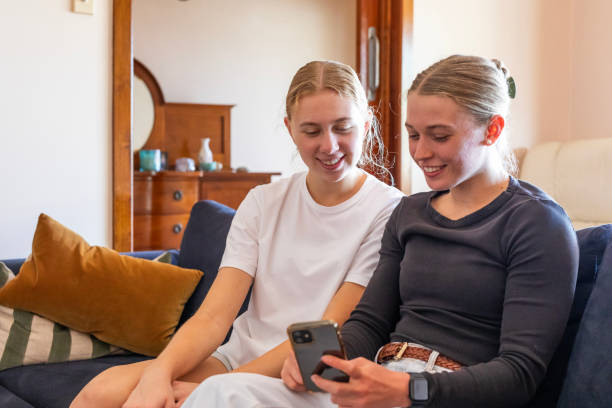 istock Happy young women using phone at home 1785219246