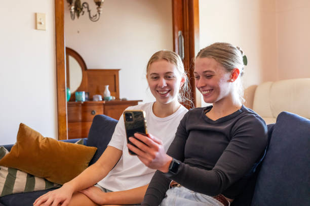 istock Happy young women using phone at home 1785219339