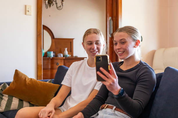 istock Happy young women taking a selfie at home 1785219359