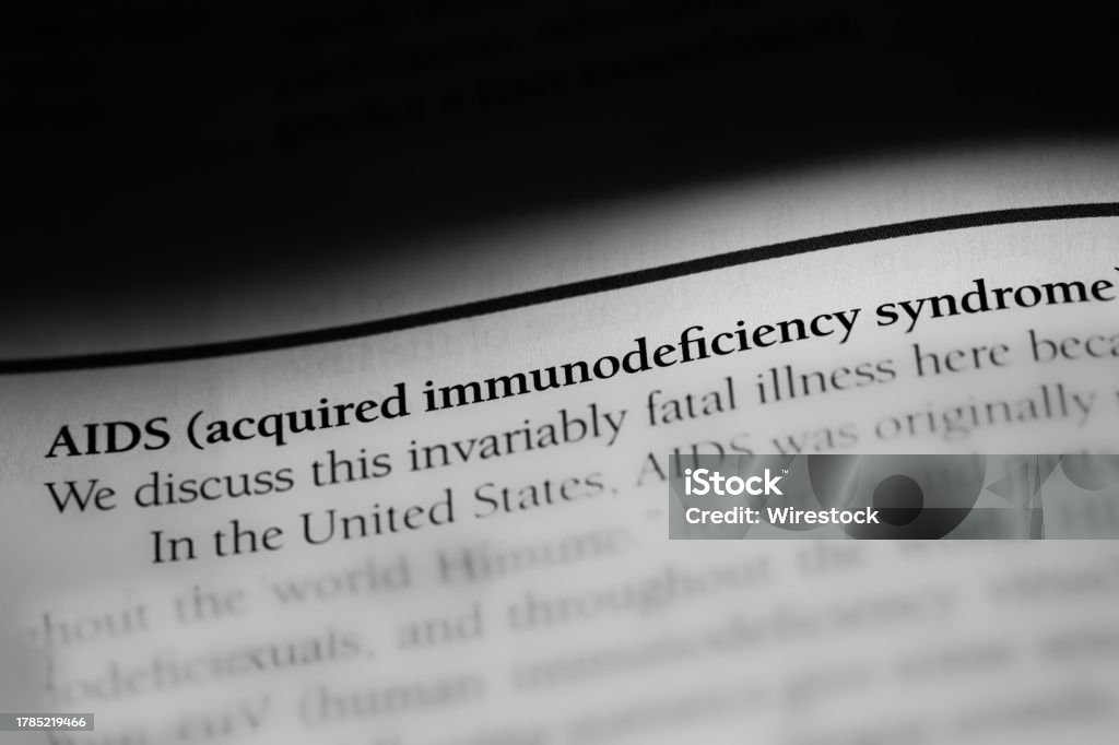 Close-up of the term AIDS, acquired immunodeficiency syndrome printed in black on white paper A close-up of the term AIDS, acquired immunodeficiency syndrome printed in black on white paper AIDS Stock Photo