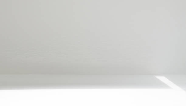 istock The refraction of light and shadow in an empty white space room. 1785221161