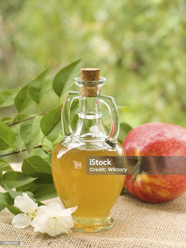 Apple cider vinegar Apple cider vinegar in glass bottle, selective focus Apple - Fruit Stock Photo