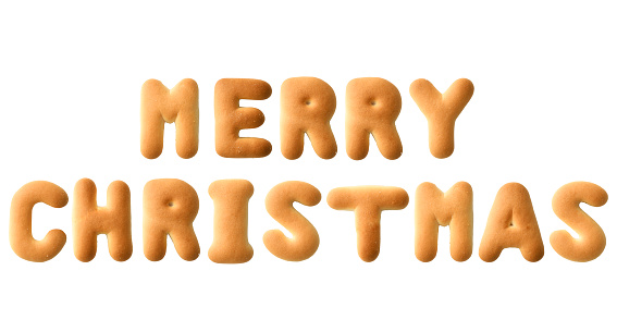 Close-up of MERRY CHRISTMAS written with alphabet biscuit on white background.