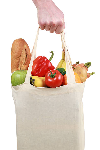 istock Hand holding a shopping bag filled with groceries 178522848