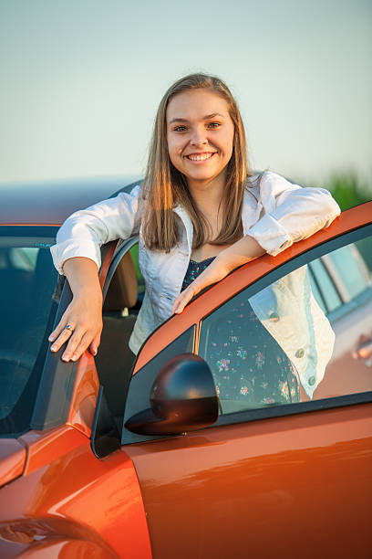 Proud teen with her new car stock photo