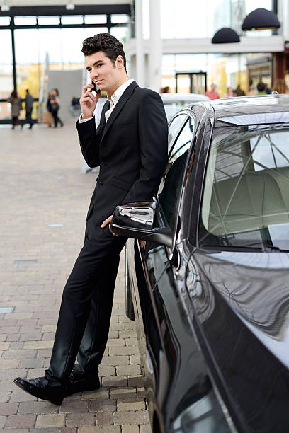 istock Young handsome man wearing suit with luxury car 178524033