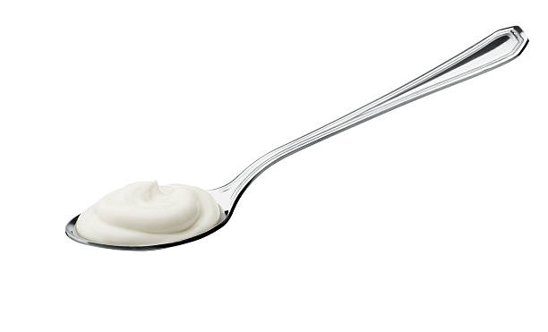 joghurt auf löffel - yogurt stock-fotos und bilder