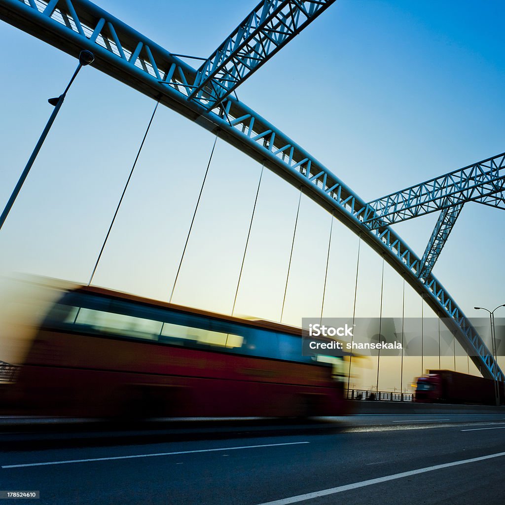 bridge "truck speeding through a bridge at sunset,motion blur." Activity Stock Photo