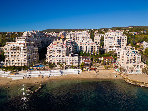 Aerial view of a luxurious modern seaside residential complex.