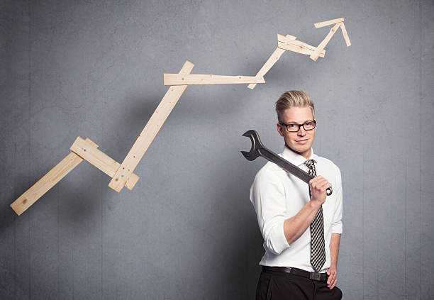 istock Smiling businessman with wrench and graph. 178526468