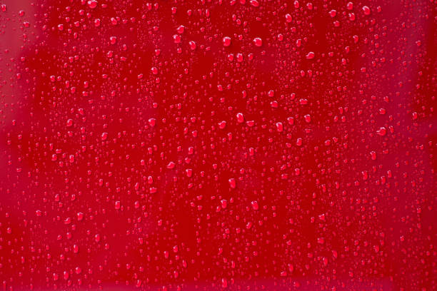 istock A group of liquid drops on a bright red background 1785266497
