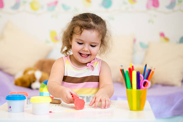 istock kid girl playing with colorful clay 178526903