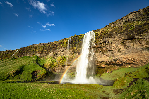 Famous place in Southern Iceland Seljalandsfoss waterfall lovely blue sky background Icelandic natural landscape Northern Europe
