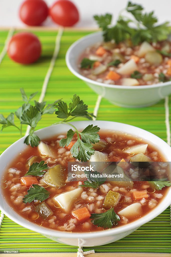 Soup with pickled cucumbers, barley  and tomato paste Soup with pickled cucumbers, barley  and tomato paste in bowl Barley Stock Photo