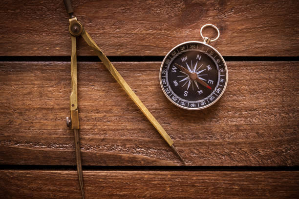 istock Vintage drawing and navigational Compass on a rustic wooden board 1785271388