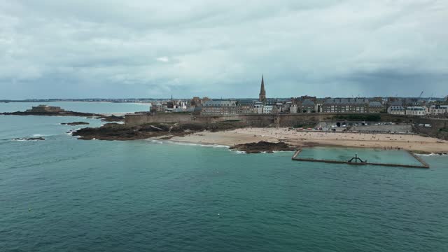 Saltwater pool on beach of Saint-Malo old city, Plage de Bon Secours, France. Aerial drone view and space for copy