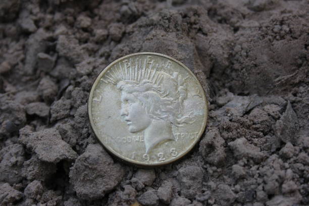 istock 1923 Silver Peace Dollar On Ground in Dirt. Front View 1785272845