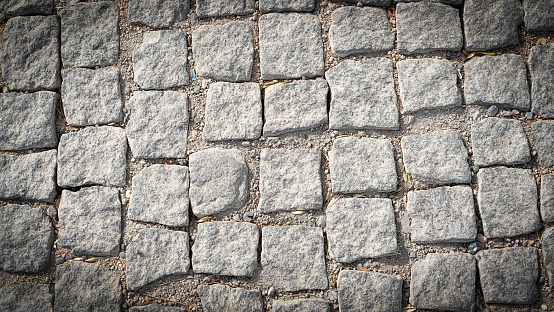 Stone pavement texture. Abstract background of cobblestone pavement. High quality photo