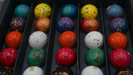 Candy chocolate balls sweats sprinkled with pigments in box. High quality photo