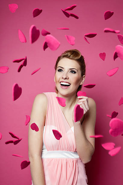 istock Beautiful young woman with hearts falling around 178528067