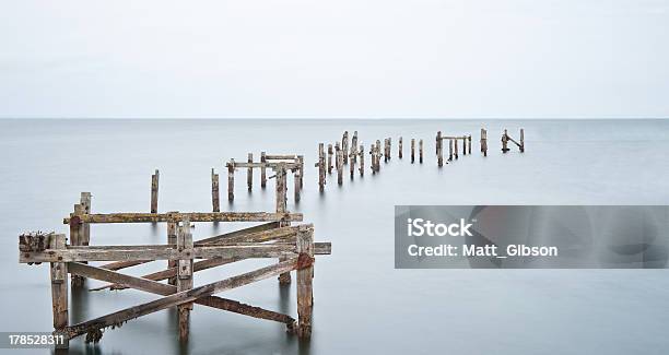 Long Exposure Derelict Pier In Calm Sea Stock Photo - Download Image Now - Abandoned, Barren, Blurred Motion