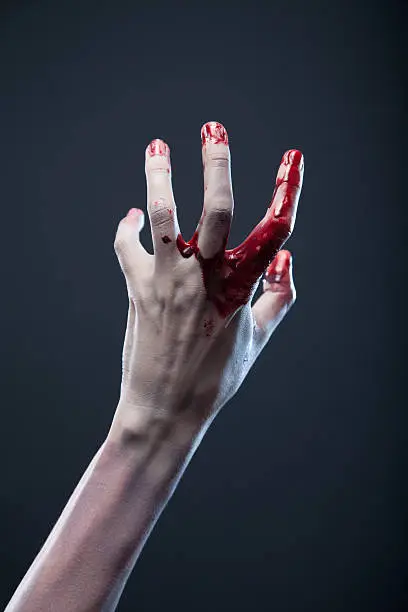 "Bloody zombie hand, extreme body-art, studio shot"