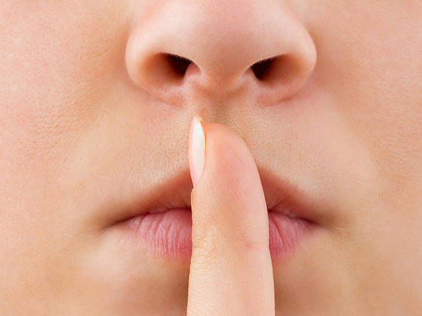 istock Woman holding finger to lips 178528664