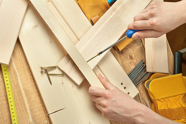 screw and screwdriver on a wooden background. stock photo