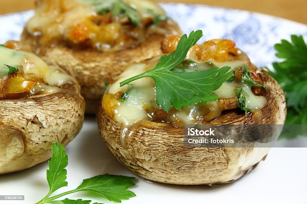 Stuffed champignon Delicious stuffed mushrooms with meat and cheese. Appetizer Stock Photo