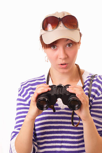 Attractive young girl with binoculars stock photo