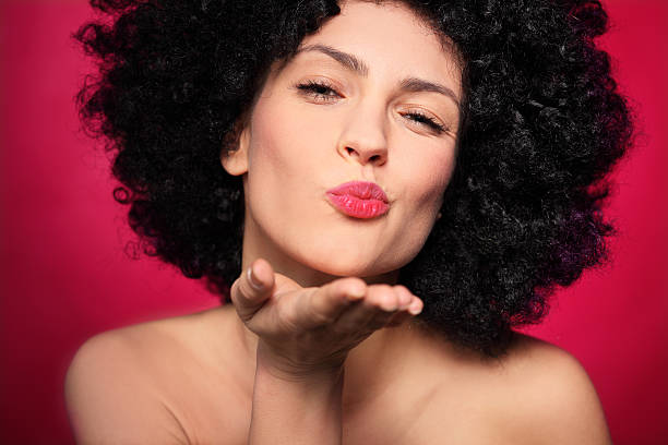 istock Woman with afro blowing a kiss 178529111