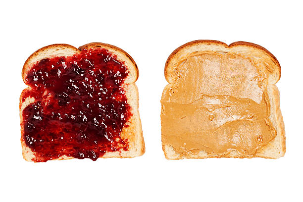 Peanut Butter and Jelly Toast "Peanut butter toast next to jelly toast. Isolated on white, shot from above." peanut butter stock pictures, royalty-free photos & images