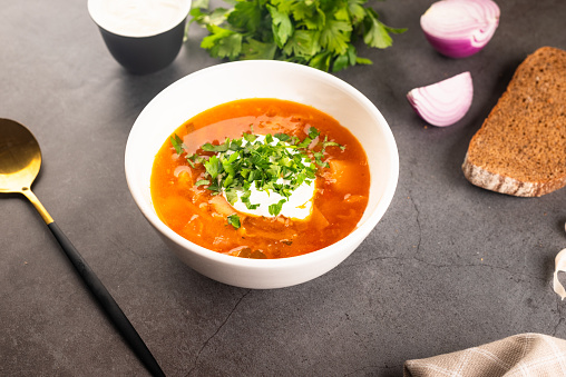 Tomato Soup with cheese and fresh mint leaves.