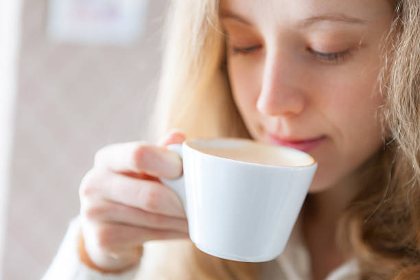 istock Coffee. Beautiful young woman drinking hot beverage 178530796