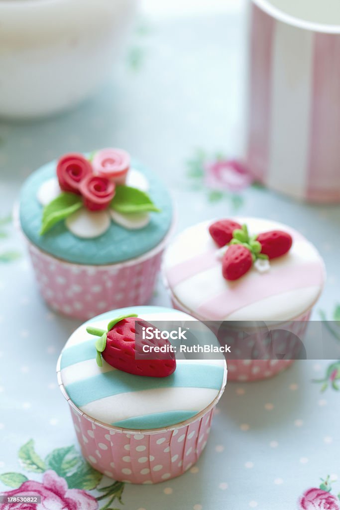 Cupcakes Cupcakes decorated with fondant strawberries and rosesMore from my portfolio - Cake Stock Photo