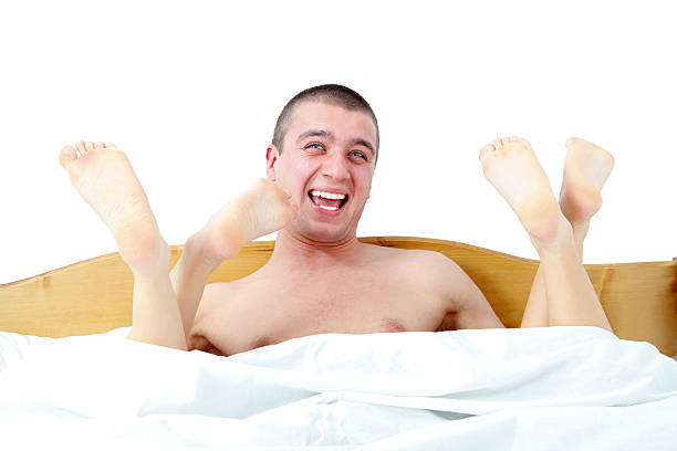 Excited guy with two girls in his bed Very happy guy being excited about having two girls in his bed. menage trois stock pictures, royalty-free photos & images