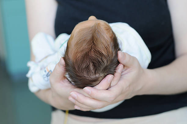 istock Mother holding newborn baby`s head 178532334
