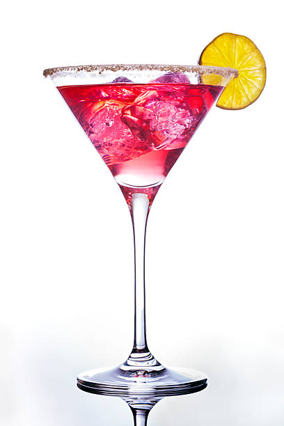 Pink colored cocktail adorned with an orange slice