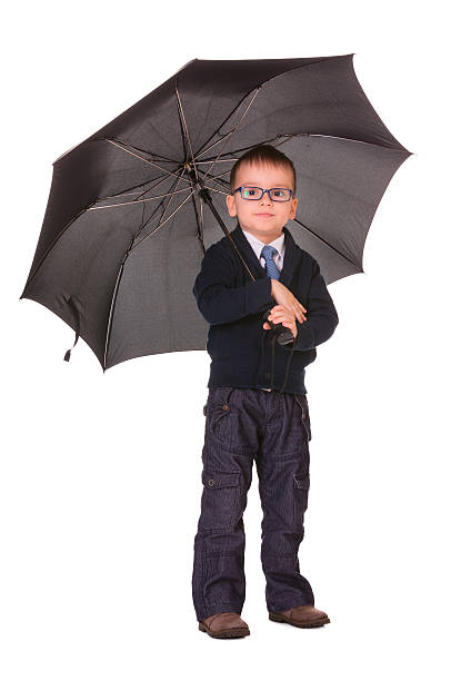 istock Boy in black clothes standing under umbrella 178533297