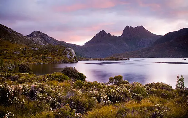 The iconic image of Tasmania, Cradle Mountain sits majestic atop the the jewel that is Dove Lake bathed in glowing sunset light.