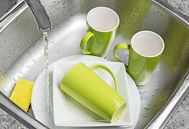 istock Washing green cups and plates in the kitchen sink 178533739
