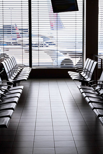 Airport waiting area with empty seats and aircrafts. stock photo