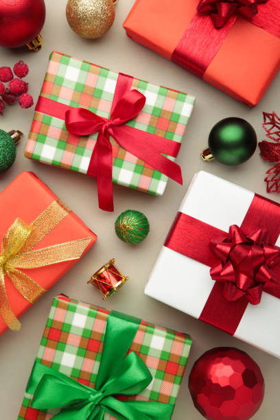 istock Christmas composition. Gifts, with green and red decorations on grey background. New year concept. Vertical photo 1785344907