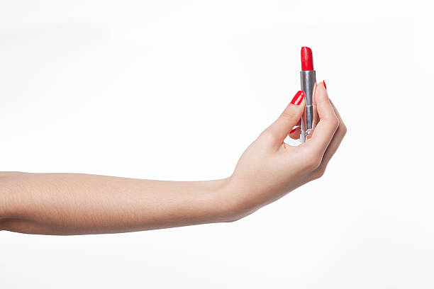 istock female hand holding lipstick 178534514