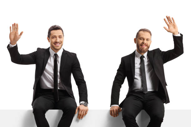 istock Businessmen sitting on a panel and waving 1785359245