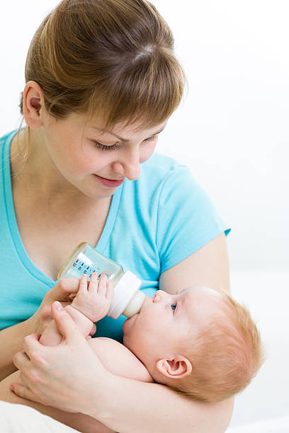 istock mother feeding baby from bottle 178536227