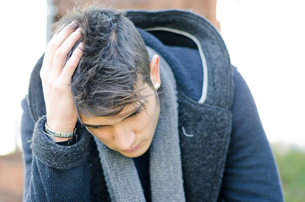 istock Desperate, sad or upset young man holding his head 178536272