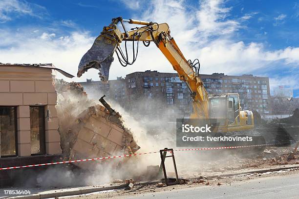 Building Demolition Machine Pulls Down A Wall On A Sunny Day Stock Photo - Download Image Now