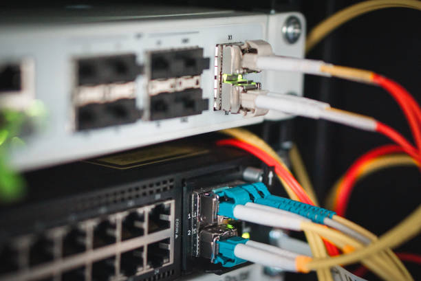 istock Optical gigabit sfp transceiver modules on networking switch in data center room with fiber optic cables connected 1785367654