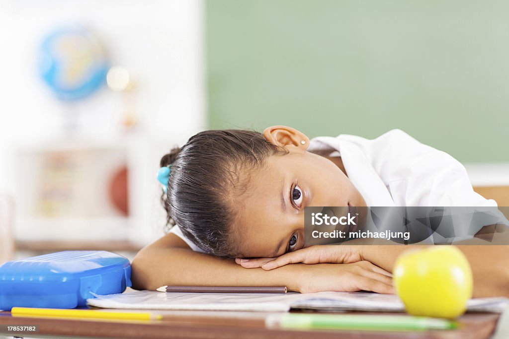 primary schoolgirl resting primary schoolgirl resting on desk Illness Stock Photo